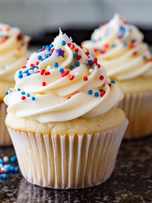 Fourth of July white dairy-free cupcakes with red, white, and blue sprinkles